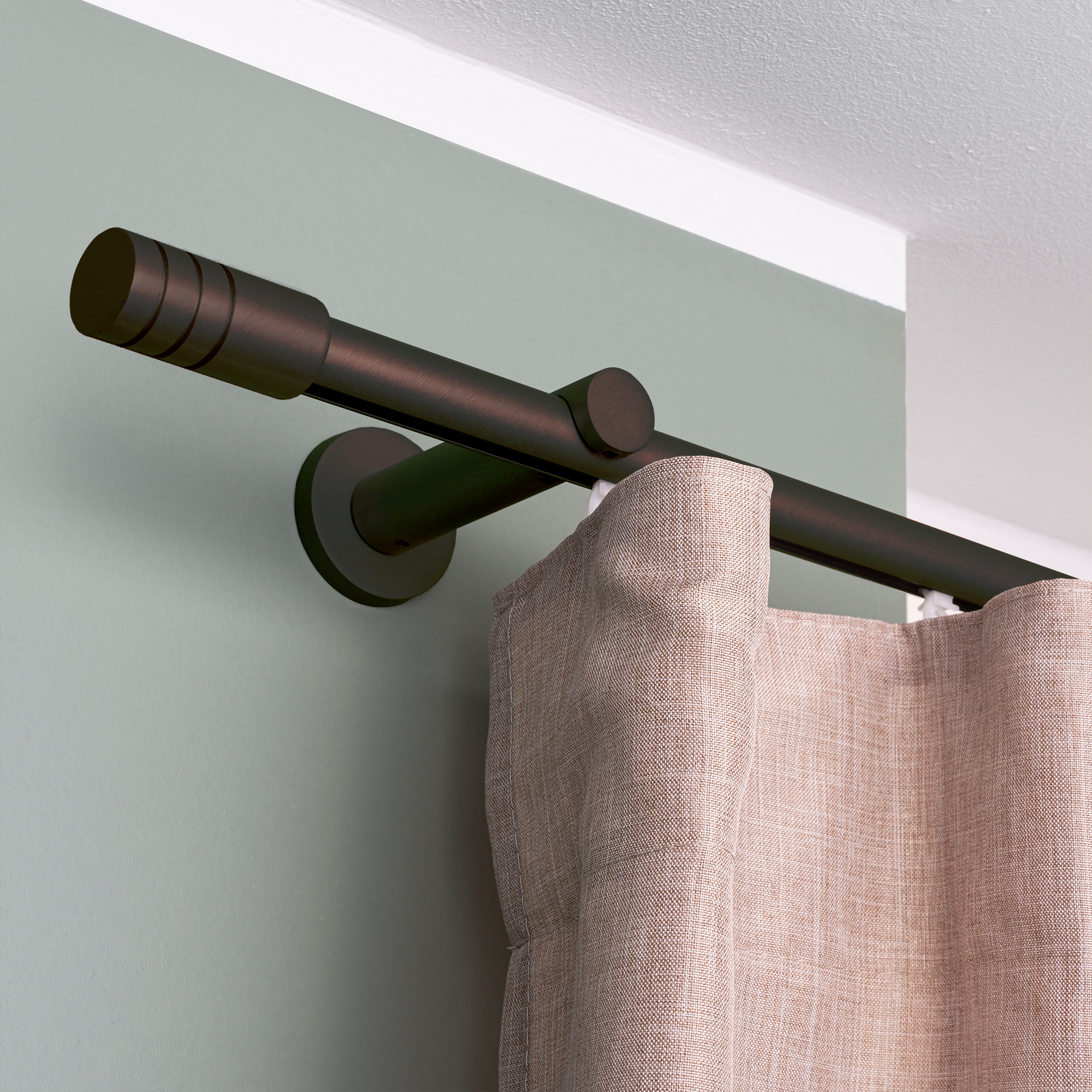 Gardinenstange mit Innenlauf und montiertem Vorhang an der Wand befestigt