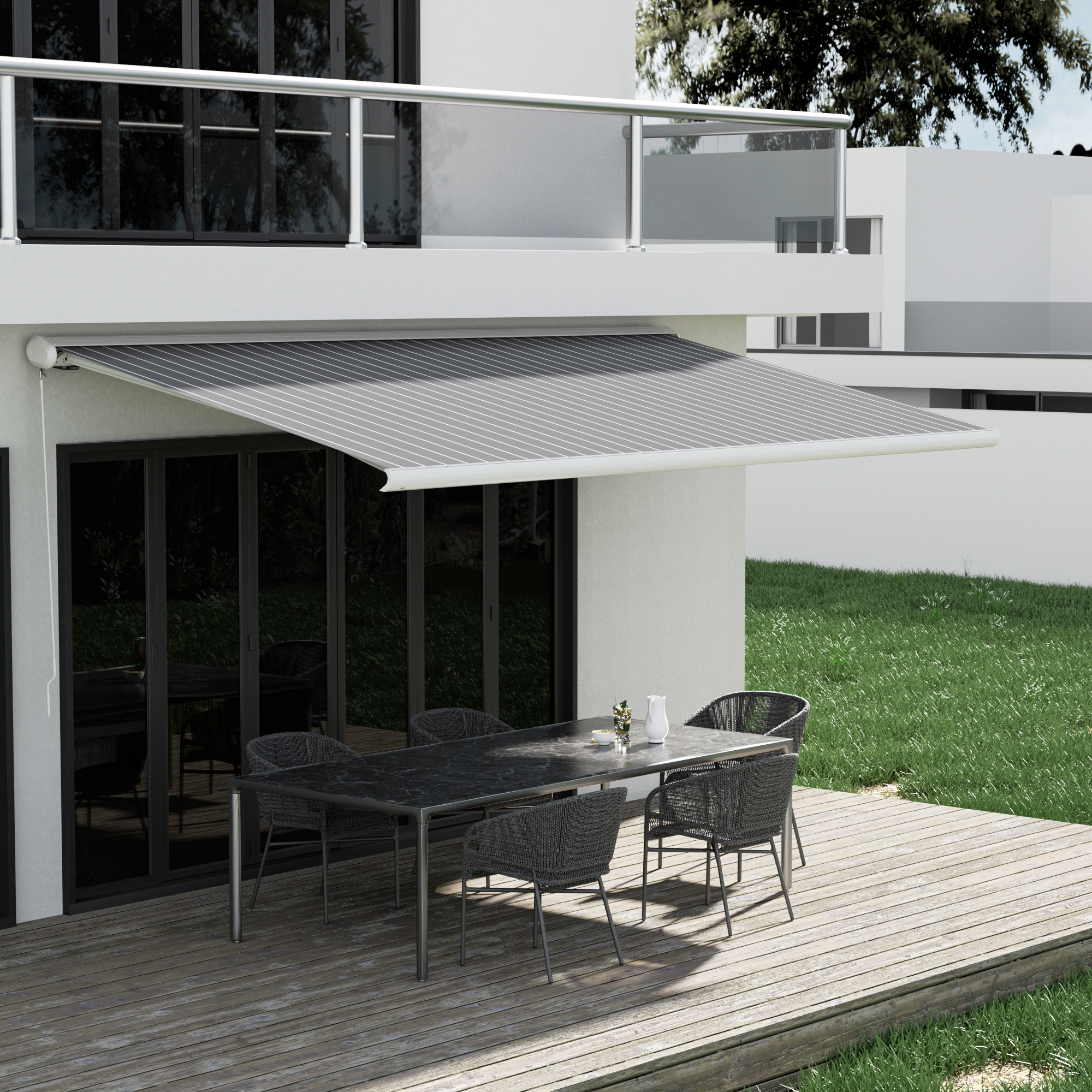 Terrasse mit Markise und Sitzmöbeln vor einem modernen Gebäude