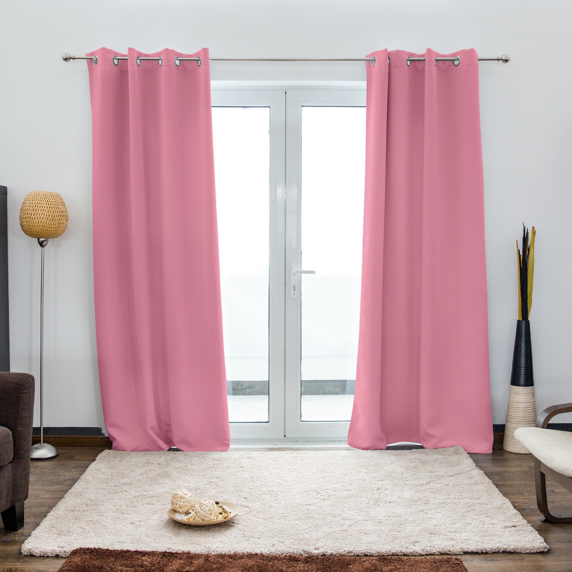 Ösenvorhang vor einer Glastür in einem Wohnzimmer mit Teppich und Stehlampe